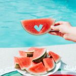 Snacking on some watermelon by the poolside in the hot summer weather!