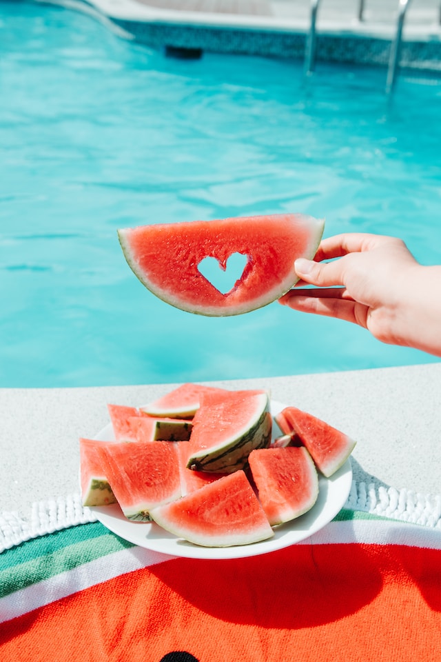 Snacking on some watermelon by the poolside in the hot summer weather!